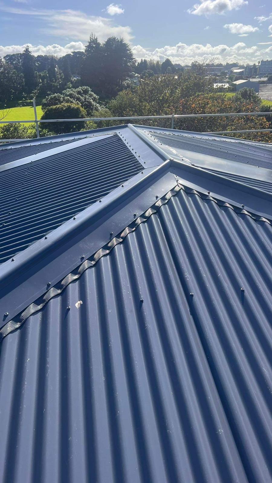 Blue corrugate hip roof installation