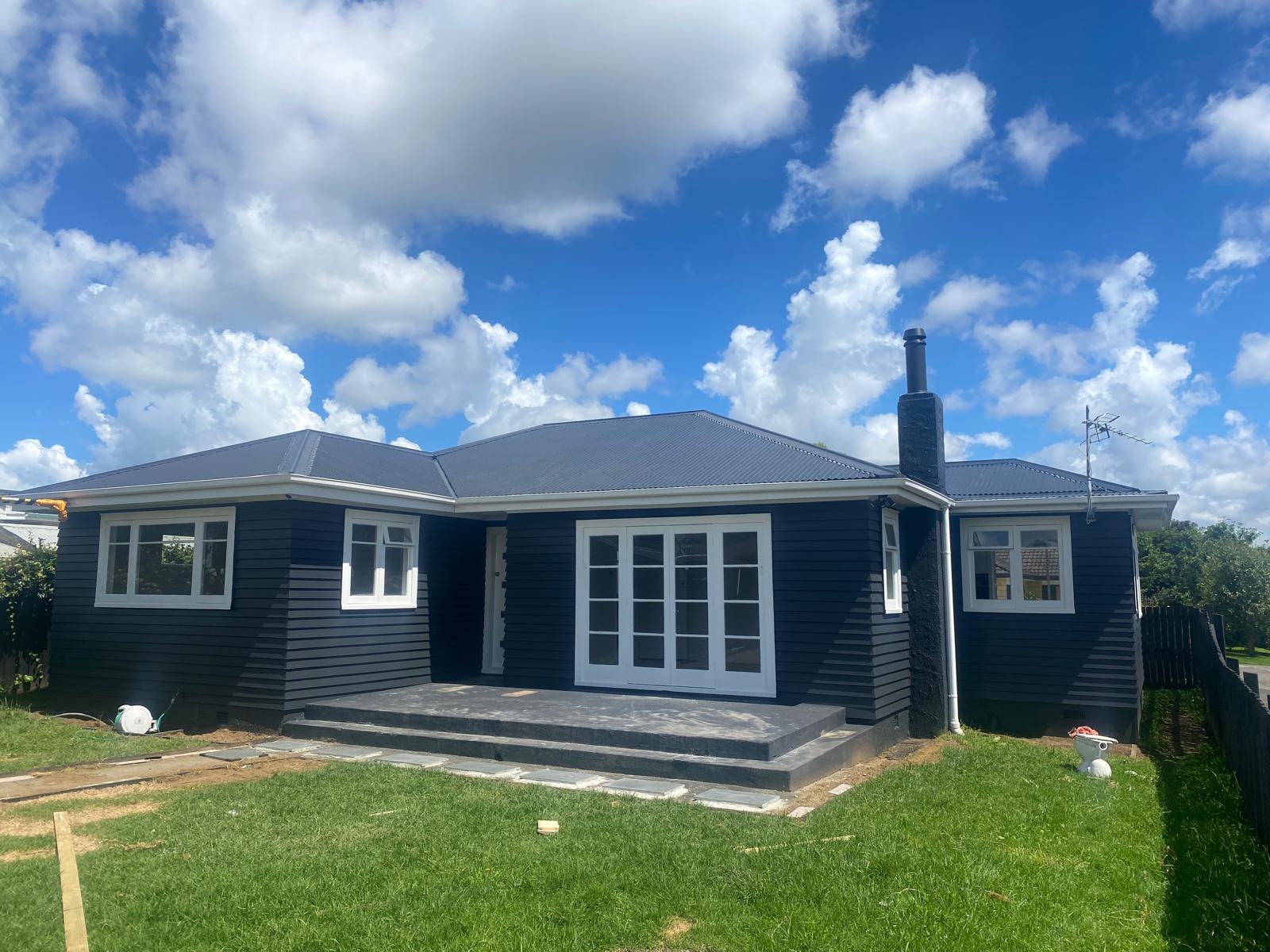 Completed dark long-run roof on a weatherboard home