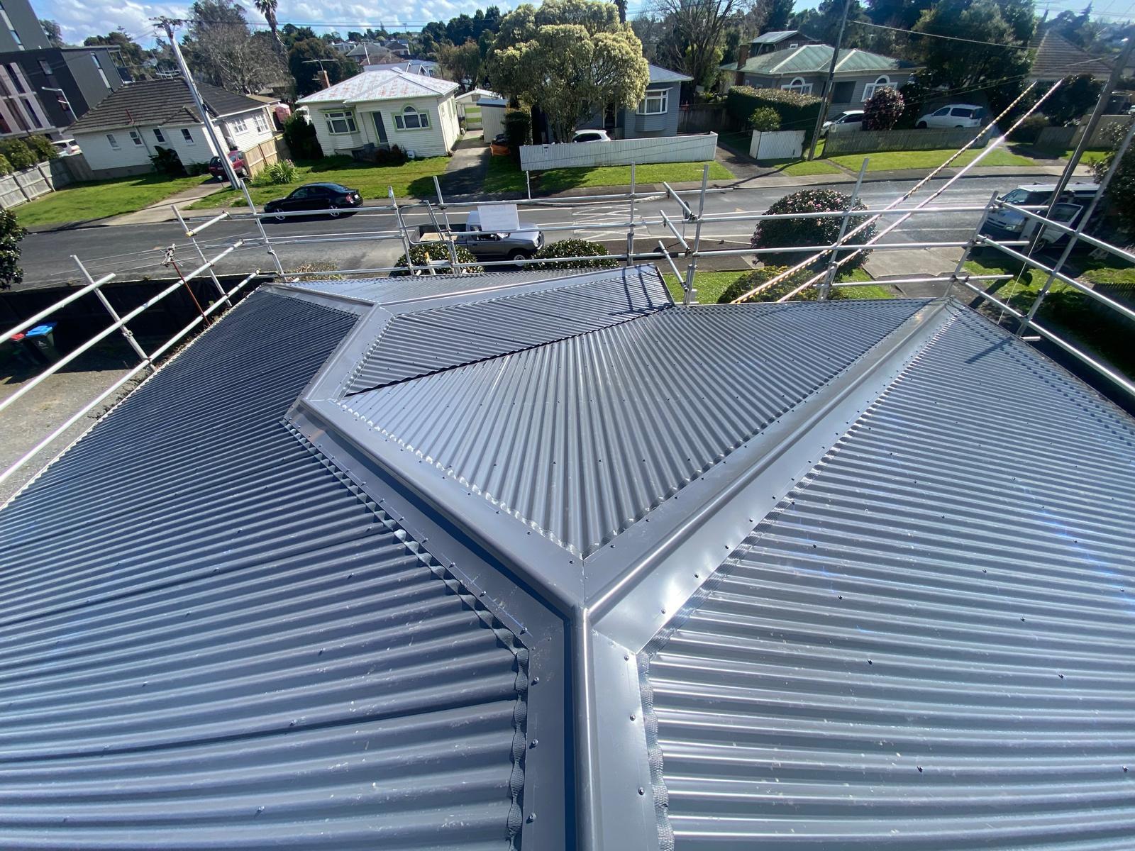 Aerial view of a completed grey hip roof